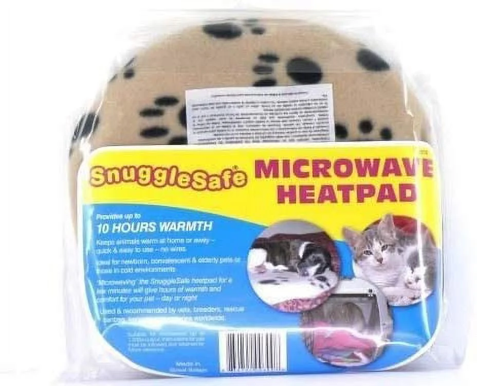 A round microwavable pet heat pad placed beside a rabbit hideout on a fleece-covered floor, set up so the animal can choose to sit near it or move away